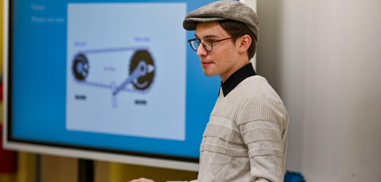 Boy by projector screen